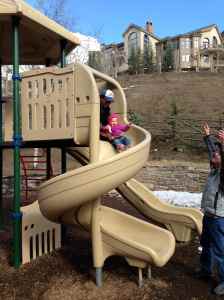A big kid on the big kid slide
